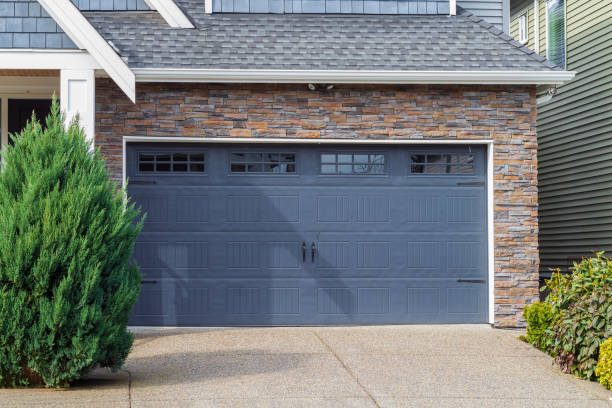 House with blue Garage door with windows . Vancouver, Canada. Garage door in luxury house. Street photo, nobody, residential garage. Insulated garage door. Metal door.